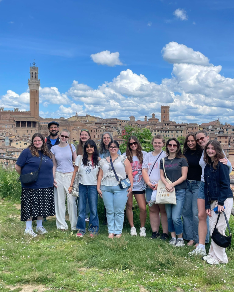 Group photo of students from Ohio with Siena in the background